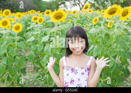 Beautiful little girl and sunflower Stock Photo
