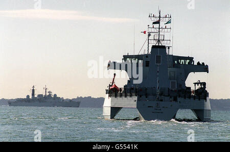 RV Triton (right), the world's first Trimaran Warship, sails at sea on the Solent at Portsmouth with HMS Glasgow behind her for her press launch. * Over the next two years DERA's RV Triton has a heavy programme of trials which will test her performance in a variety of sea conditions. She was officially handed over to DERA during a short ceremony on, and is now berthed at her new home at Portsmouth Naval Base. Stock Photo