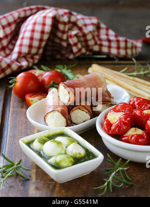 Italian appetizer antipasti made dish - ham, cheese, peppers Stock Photo