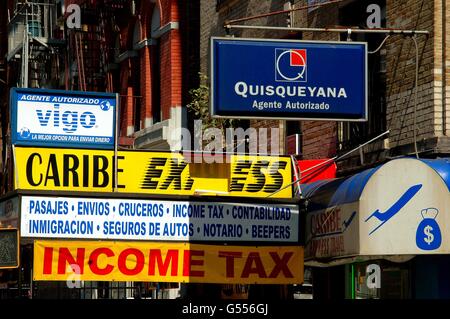 New York City: Signs in English and Spanish for legal and accounting services hang outside storefronts in Harlem Stock Photo