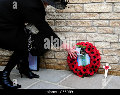 A woman lays a wreath at the new memorial commemorating the 255 British servicemen who died in the Falklands War, unveiled at the National Memorial Arboretum in Staffordshire. Stock Photo