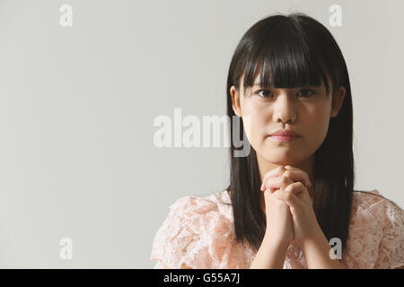 Japanese young woman praying Stock Photo