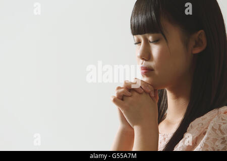 Japanese young woman praying Stock Photo