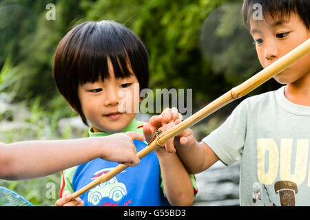 Japanese kids playing at the river Stock Photo