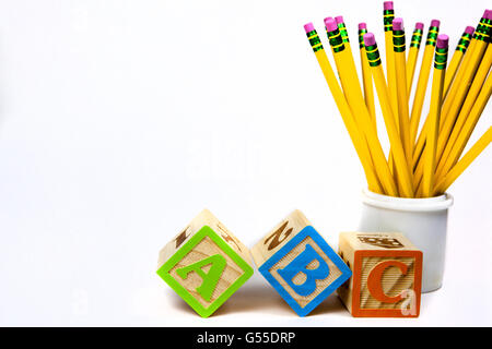 ABC wooden blocks with yellow pencils. Stock Photo
