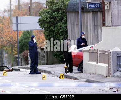 Police and forensic experts examine the front of Castlewellan Royal Ulster Constabulary station, where a bomb exploded, seriously injuring one RUC officer. Dissident republicans are being blamed for the bomb attack. *... which came just hours after two Protestants were shot dead in north Belfast in separate attacks. Stock Photo