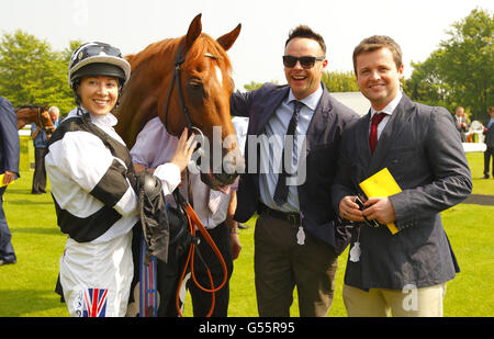 Anthony McPartlin (second right) and Declan Donnelly (right) with jockey Hayley Turner, rider of their horse Primaeval after winning the Wright Joinery Company Stakes during day one of the May Festival at Goodwood Racecourse, Chichester. Stock Photo