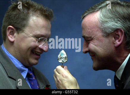 Chief Executive of the Millenniun Dome PY Gerbeau (L) and Executive Director of De Beers Andy Coxon at the De Beers building in London, taking a closer look at the 203 carat Millennium Star, the largest flawless pear-shaped diamond in the world. * The diamond formed part of a display worth 350 million that a 12 strong gang of robbers attempted to steal from the Money Zone in the Millennium Dome on 07/11/00 using an earth digger, smoke bombs and a powerboat. Stock Photo