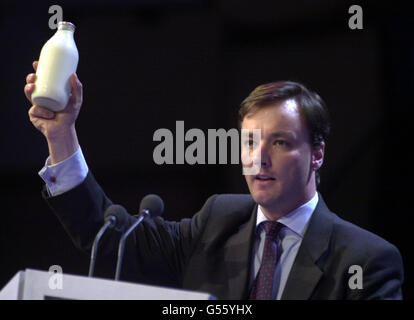Adrian Flook holds aloft a pint of milk, as he speaks during the second day of the Conservative Party Conference held in Bournemouth. Stock Photo