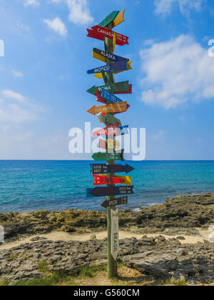 Signpost pointing at different cities Stock Photo