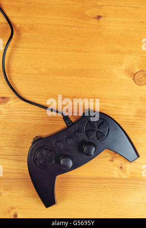 Gamepad controller on wooden desk, flat lay top view, gaming and entertainment concept with copy space Stock Photo