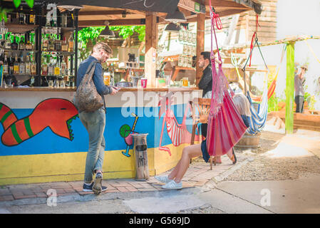 Cool couple bar, view in summer of a young couple relaxing in a ruin bar in the Erzsebetvaros district of Budapest, Hungary. Stock Photo