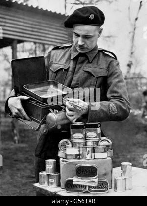 A Warrant Officer of the 14/20th King's Hussars with a cooker and food supplies. Members of the Voluntary Aid Detachments and Auxiliary Territorial Service, as well as the Army, are training to become cooks at the Army Catering Corps Training Centre, formerly the Army School of Cookery. The centre not only thinks of today but will help men to get work in the catering industry after the war. Stock Photo