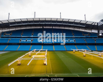 Lighting rigs to provide artificial sunlight in winter for the grass on the pitch , Etihad Stadium Manchester City UK Stock Photo