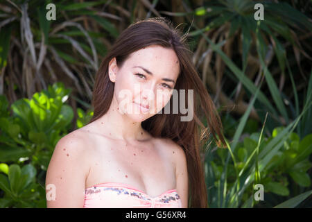 Young beautiful mixed race woman on the beach in bikini smiling Stock Photo