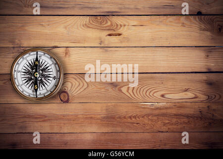 old compass on wood background and texture with space Stock Photo