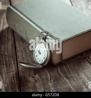 Vintage pocket watch on old books. Close up photo Stock Photo