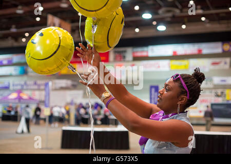 Detroit, Michigan - A woman with smiley face balloons during the Service Employees International Union convention. Stock Photo