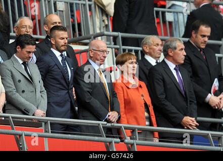 Soccer - International Friendly - England v Belgium - Wembley Stadium. David Beckham (2nd left), Sir Bobby Charlton (centre) and Peter Shilton (right) in the stands during the national anthem Stock Photo