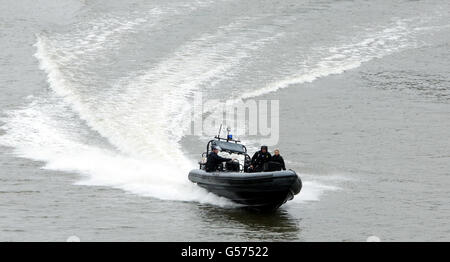 A police boat near Tower Bridge on the River Thames in London, ahead of the start of the Diamond Jubilee river pageant. Stock Photo