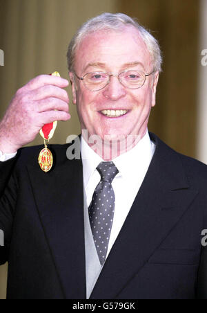 Actor Michael Caine at Buckingham Palace in London, after receiving a knighthood from Britain's Queen Elizabeth II. Knighted as Sir Maurice Micklewhite - his real name. *...the Bermondsey-born son of a Billingsgate fish porter and London charwoman remains a prolific movie actor whose portrayals include the bespectacled Harry Palmer in the Len Deighton spy thrillers, Cockney Lothario Alfie Elkins in Alfie, and Charlie Croker in The Italian Job. Stock Photo