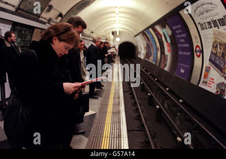 Passengers underground. Passengers waiting for a tube train on a London Underground station platform. Stock Photo