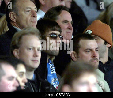 Oasis singer and Manchester City fan Liam Gallagher (wearing sunglasses) watches his team play Manchester United, in their FA Premiership derby football match at Maine Road, in Manchester. Before the match he confirmed that he and All Saints singer Nicole Appleton are expecting a baby.'It's true and it's absolutely great - hooray, said Gallagher, 28. Nicole is going to be a great mum - the best mum in the world.' Speaking at the home of his mother, Peggy, in Burnage, Manchester, the singer said Nicole, 25, was less than two months pregnant. Stock Photo