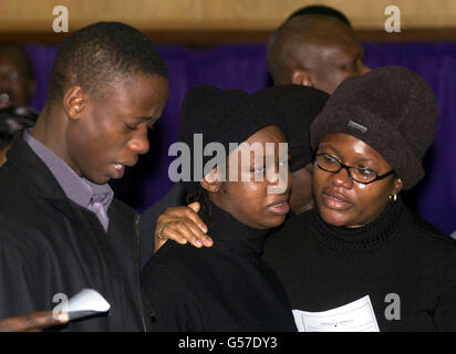 Tunde Taylor, 21 (left), the brother of murdered schoolboy Damilola Taylor and his sister Beme, 23 (centre), at the Mountain of Fire and Miracles Ministries in London's Old Kent Road during the memorial of the 10 year old, who died 10 days ago. Stock Photo