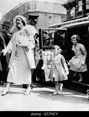 The Duchess of York (later Queen Elizabeth and the Queen Mother) arrives by car at the Royal Tournament in London accompanied by her daughters, Princess Elizabeth (r) and Princess Margaret. Stock Photo