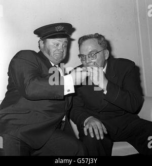 Allan Smethurst (right), The Singing Postman, asks for, and Harry Secombe obliges by supplying a light as the two singing comedians joked together at the Variety Club. * 23/12/2000: Allan Smethurst, The Singing Postman who died aged 73. He had a number of hits in the Sixties including I Miss My Miss from Diss, but his biggest hit was Hev Yew Gotta Loight Boy which won him and Ivor Novellow award in 1966. Mr Smethurst broke his hip in a fall three months ago and his health deteriorated it was reported. Stock Photo