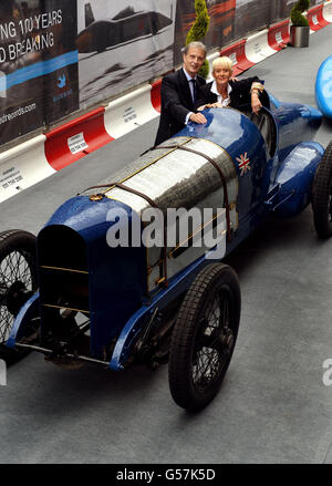 Gina Campbell, daughter of Donald Campbell and Don Wales, the grandson of Sir Malcolm Campbell, sit on the Sunbeam 350hp car that broke the World land speed record of 146.16mph, by their grandfather Sir Malcolm on Pendine Sands in Wales in 1924, outside the Theatre Royal Haymarket in central London. Stock Photo