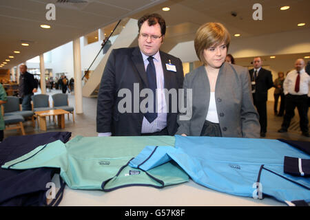 Health Secretary Nicola Sturgeon talks to Director of Nursing Rory Farrelly (l) during a visit to the New Stobhill Hospital in Glasgow to launch of the new NHS Scotland national uniforms Stock Photo