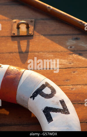Life belt on deck of fishing boat bathed in warm sunlight Stock Photo