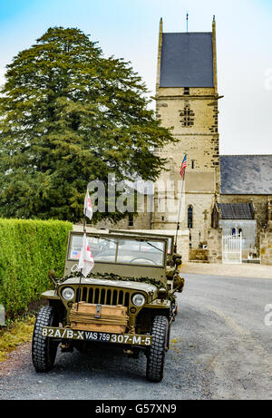 Angoville-au-Plain, Carentan, Normandy, France – A Willys MB truck ¼ ton 4x4 Jeep fitted in ambulance fit outside the church Stock Photo