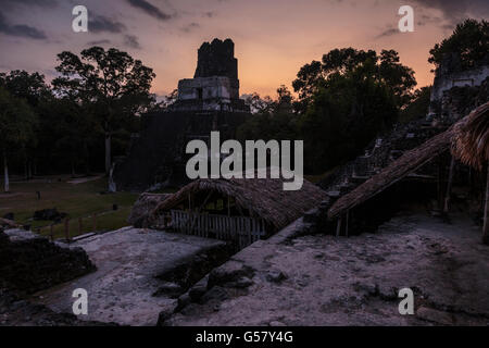 Dusk settles over the Temple of the Masks, temple 2, in the grand plaza of Tikal, guatemala, as seen from the North Acropolis Stock Photo