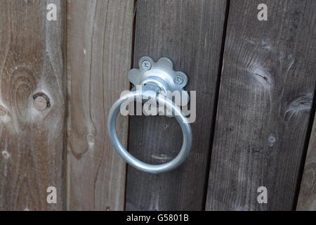 Silver Handle on a Wooden Door Stock Photo