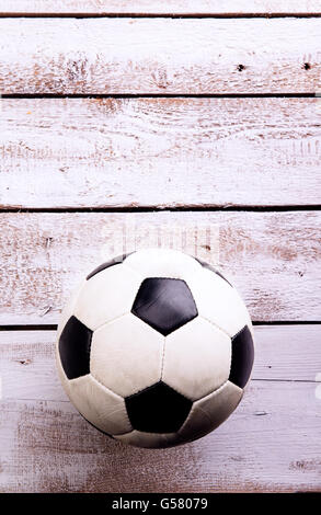 Soccer ball against wooden background. Studio shot. Copy space. Stock Photo
