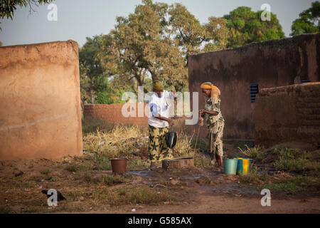 Women draw water from a shallow well in Bobo Dioulasso Department, Burkina Faso. Stock Photo