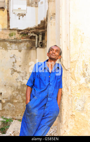 Cuban man leaning against wall in the ruins of an old building, La Habana Vieja, Old Havana, Cuba Stock Photo