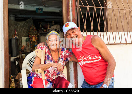 Seniors, Cuban couple happily smiling and chatting in a street scene in La Habana Vieja, Old Havana,Cuba Stock Photo