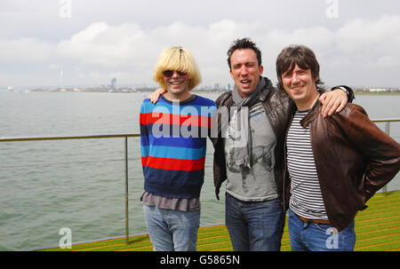 Tim Burgess (left) and Mark Collins (right) from The Charlatans, who will play at the Isle of Wight Festival in Newport this weekend, with Absolute Radio DJ Christian O'Connell on Spitbank Fort in the Solent between Portsmouth and the Isle of Wight. Stock Photo