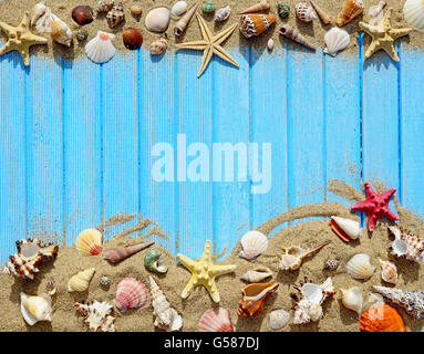 Sand, seashells and starfish on a wooden background Stock Photo