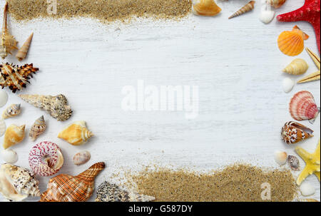 Sand, seashells and starfish on a wooden background Stock Photo