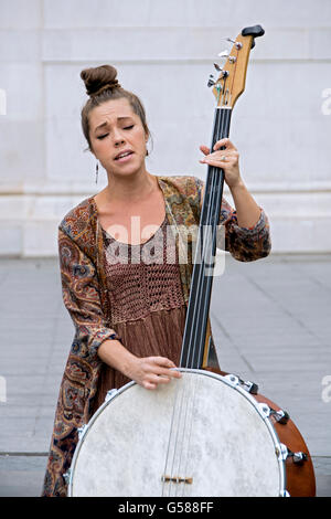 The bassist the team of Coyote & Crow playing a one of a kind homemade string bass in Greenwich Village, New York City Stock Photo