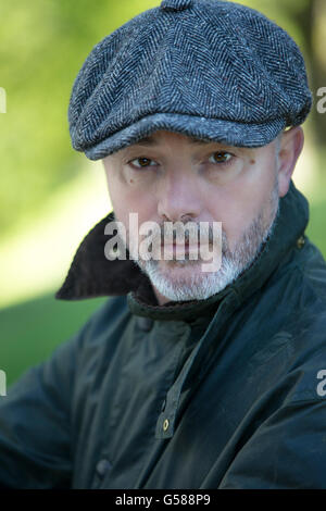 Close up shot of a man wearing a coat and cap Stock Photo