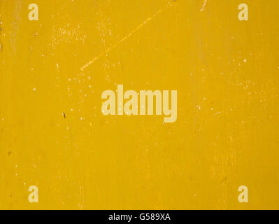 Rusty old metal surface painted in a dirty deep yellow color Stock Photo