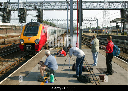 A Virgin Pendolino with a northbound service attracts enthusiasts attention entering Crewe