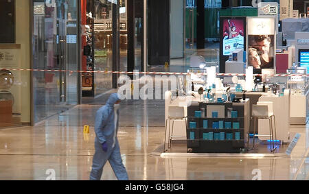 A forensics officer attends the scene at Westfield in Stratford, east London, after a man was stabbed to death. Stock Photo