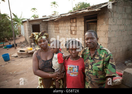 A family stands together outside their house in Nampula, Mozambique. Stock Photo