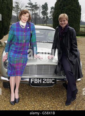 The first Miss Moneypenny, Lois Maxwell (left) and the current Miss Moneypenny, Samantha Bond with the famous silver 1965 Aston Martin DBS driven by Pierce Brosnan in the film Goldeneye, during a Christie's sale preview at Stoke Park Club. * The car is expected to fetch between 100,000 - 150,000 during a sale of Bond memorabilia. Stock Photo